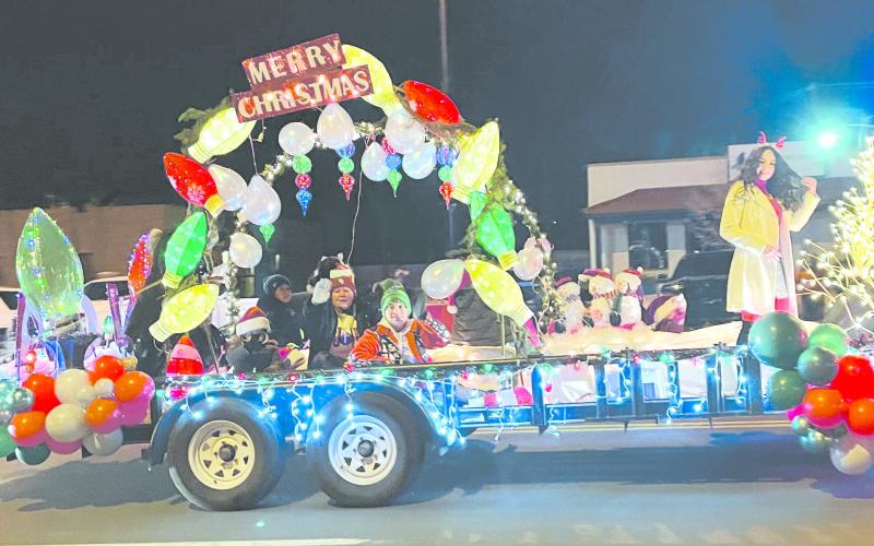PARADE OF LIGHTS The Perryton-Ochiltree Chamber of Commerce hosted a Christmas Parade of Lights downtown on Dec. 3. The parade ran down Main Street from Ninth to Brillhart, as vehicles and floats decked out in festive Christmas lights entertained the large crowd on hand and worked to fire up everyone’s holiday spirit. Pictured above is Victory Christian Academy’s entry in the event.