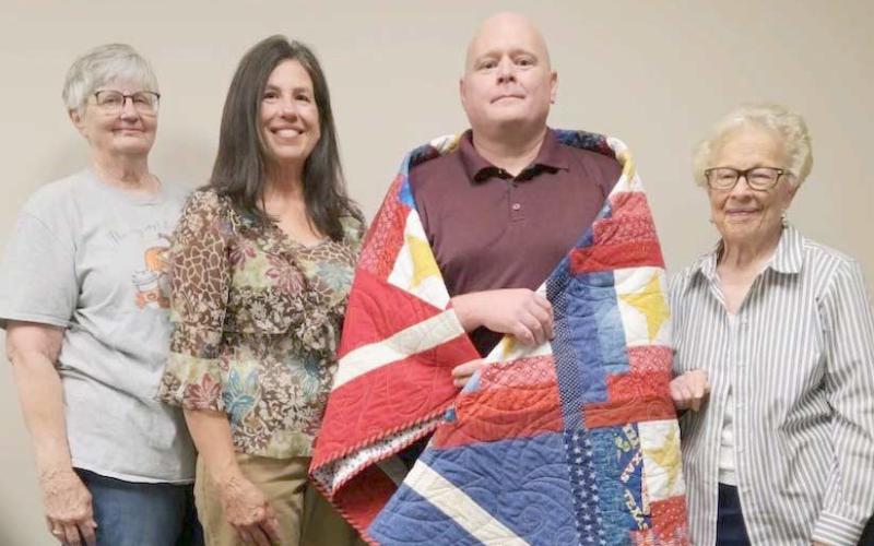 QUILTS OF VALOR— The second group of veterans honored with Quilts of Valor by the Friendship Quilt Guild were, top photo, from left, first row, Bob Lucas, Jeff Lewis, Nathan Ellzey and Vance Snider II; and second row, Senn Slemmons, Wayne Cummings, David Rogers and Lynn Stedji. In the bottom photo, Brad Wooster (third from left) was unable to attend the event, but received his quilt earlier from guild members Sheril Kelley, Randi Ortega and Freddie Seaman.
