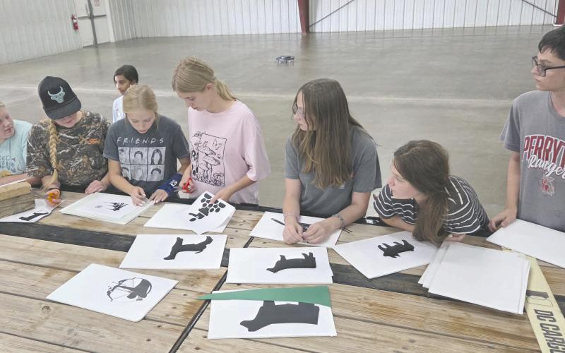 Many organizations and businesses are hard at work preparing their floats for Saturday’s Wheatheart of the Nation Celebration parade, which will march down Main Street starting at 10 a.m. Pictured making plans for decorations for the Ochiltree County 4-H float are, from left, Rebekah Young, Hannah Young, Eden Salazar (in the background), Emmalee Lopez, Darlee George, Kylee Knox, Kaylynn Tarango, and Lou Tarango.