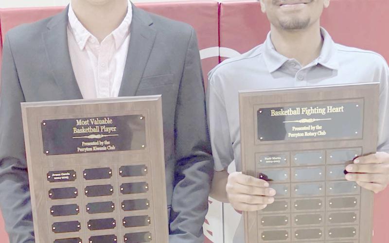 BOYS HOOPSTERS BRING HOME AWARDS— Perryton High School’s boys basketball team was honored at the Perryton High School All Sports Awards Banquet. Pictured are, from left: Avaun Garcia, who brought home the boys MVP award, and Nasir Martin, winner of the Fighting Heart award.