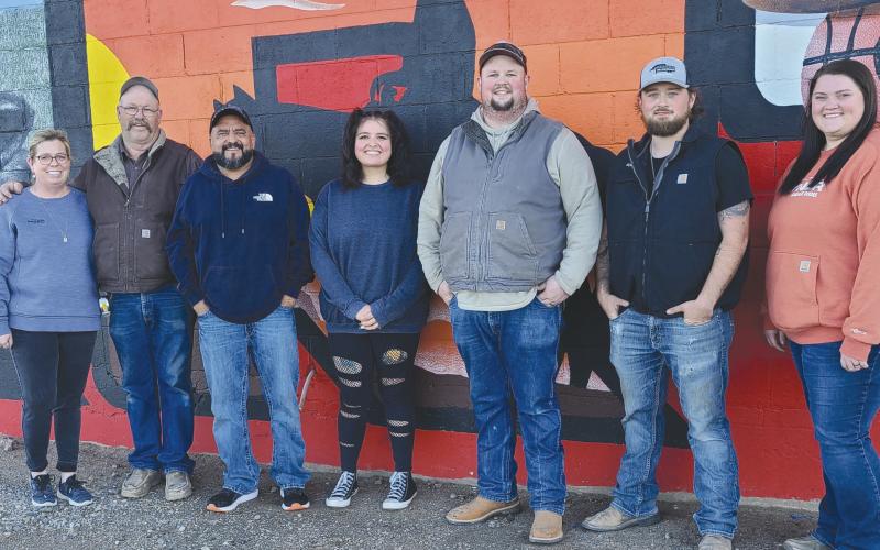 MURAL ARTST— THE new mural on the back of Perryton Glass and Overhead Doors includes several images of Perryton. Artist Mario Enriquez spent about five weeks painting the mural. Pictured are, from left, Perryton Glass owners,Lea Thomas and Brian Thomas, Enriquez, his daughter Mariah Hollibaugh who assisted on the project, Brayton Thomas, Keaton Burt, and Morgan Thomas.