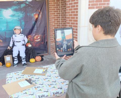 LIFTOFF FOR HALLOWEEN— Perryton residents turned out downtown on Oct. 15 for sales, entertainment, and fun snacks during the Perryton Ochiltree Chamber of Commerce’s annual Moonlight Madness event. Lots of kids showed up to enter the Chamber’s annual costume contest. Pictured are, from left, young astronaut Mason McDaniels, age 6, and Drake Vasquez, 12, taking photos of costume entrants for the Chamber.