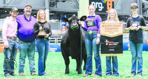 HOUSTON STOCK SHOW RESERVE GRAND CHAMP Maddie Schickedanz showed the reserve grand steer at the Houston Livestock Show and Rodeo March ??. She won the honor with TJ. Pictured from left are coach Kyle Tarter, Jason Schickedanz, Amber Schickedanz, TJ, Maddie, Sydney Schickedanz and Jake Schickedanz, all of Perryton.