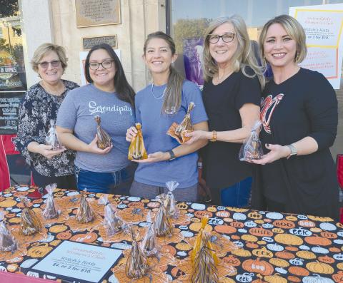 SERENDIPITY SNACKS— Perryton residents turned out downtown Thursday evening for the annual Moonlight Madness event, sponsored by the Perryton Ochiltree Chamber of Commerce. Selling “Witches Hats” treats for Serendipity were, from left, Shawn Tevis, Ana Hernandez, Amanda Cowan, Terrie Swinney, and Mandy Morgan.