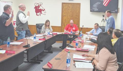 OATH OF OFFICE—Newly elected Perryton School Board trustees were sworn in during the board’s meeting. They are, standing, from left, Chris Lingo, Wes Beal and Tyler Merkel. The board also elected new officers, with Joe Ogden to serve as president, Beal as vice president and Merkel as secretary.
