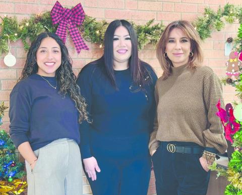 The City of Perryton has once again set up a Giving Garland this year in City Hall to assist local citizens who have difficulty paying their winter heating bills. Anyone can make anonymous donations to help pay utility bills. Pictured with the garland are, from left, city employees Sandra Sosa, Ammie Esquivel, and Laura Rivera.