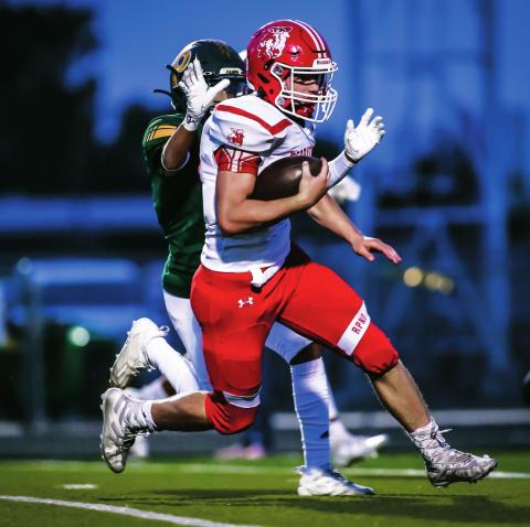 GREAT SHOW FROM THE RANGERS Brenton Heeter (#16, senior) jukes a defender as he barrelled his way to the end zone during the first quarter against the Pampa Harvesters. The Rangers shined but ultimately fell to Pampa 41-35 after two weeks off. See story for more information. (Photo by David Erickson)