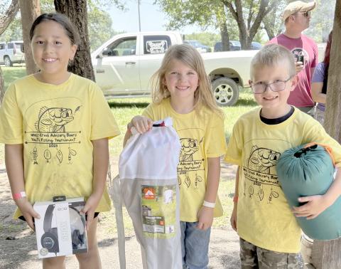 Enthusiastic young fishing fans came out for the Children’s Fishing Tournament at Lake Fryer and Wolf Creek Park at the beginning of June. Pictured are, from left, the top winners in the category for kids ages 7-10, Juliana Becerril (first place), Kinzie Anderson (second place), and Levi Nelson (third place).