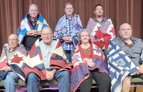 QUILTS OF VALOR RECIPIENTS— The Friendship Quilt Guild presented 16 Quilts of Valor to 16 recipients. The ceremony was held Oct. 17. The first seven recipients were, first row, from left, James Bishop, Alvin Cowan, Kay Nelson and James Bradford; and second row, Richard Barnett, Chris Gill (accepting for his son, Cody Gill) and Andrew Skipper.