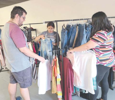 The Panhandle Crisis Center’s Resale Store opened at a new temporary location at 21 SE 12th Street on August 1. The old store sustained heavy damage in the tornado on June 15. The store will be open Monday through Friday from 10 a.m. to 5:30 p.m. No donations are being accepted at this time. Pictured getting the store restocked prior to its opening are, from left, Rhett Schaef, Jade Gonzales, and Marisol Hernandez.