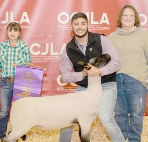 GRAND CHAMPION SHEEP—At the Ochiltree County Junior Livestock Show and Sale on Jan. 19- 20, the prize for Grand Champion Sheep went to Dalton L’Esperance. His animal was bought by Sid and Stacey Tanner. Pictured are, from left, Chloe Richardson, Dalton L’Esperance, and Stacey Tanner. (Photo credit: Tessa Powell)