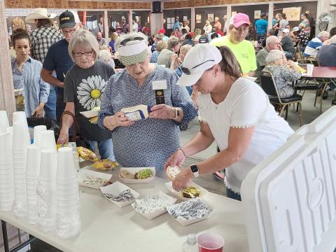 THE CHOW LINE— There was a line all the way through the Museum of the Plains on Saturday for people eager for lunch on hamburgers, hot dogs, and homemade ice cream. The museum’s annual Pioneer Day, part of the Wheatheart of the Nation Celebration, brought hundreds of visitors.