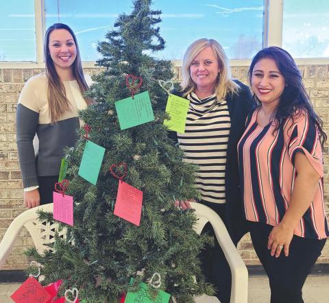 BE A CHRISTMAS ANGEL The Panhandle Crisis Center is offering the opportunity to help children in need this Christmas with the Angel Tree Project, with Angel Trees set up in local businesses to let benefactors purchase gifts for kids. Pictured with the Angel Tree in Walls Discount Center are, from left, crisis center staff members Jessica Klopper, Brada Hargues, and Carmen Mercado.