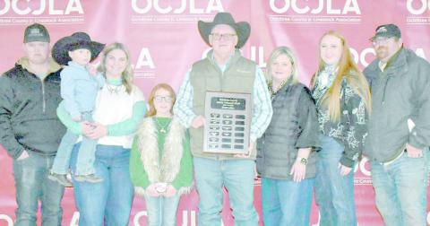 This year’s Ochiltree County Junior Livestock Show and Sale was dedicated to Gary Murry. Pictured are, from left, Logan Martin, Tucker Gillispie, Raylee Murry, Blakelee Gillispie, Gary Murry, Rhonda Murry, Ali Gillispie, and Matthew Gillispie. (Photo credit: Morgan Dudley)