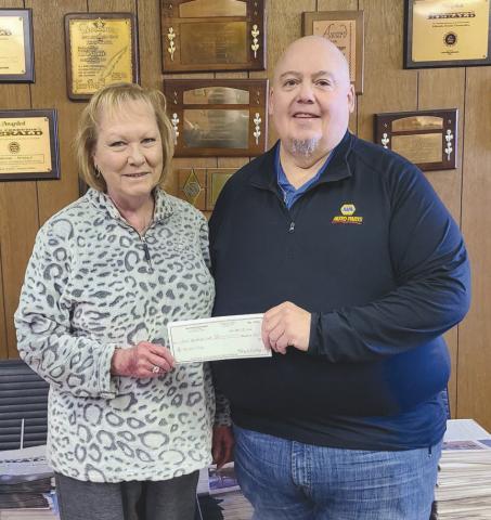 Michael Rutz, right, was the big winner of the Herald’s annual football contest and the recipient of the Goodyear Cotton Bowl package at AT&amp;T Stadium, which includes four tickets to the game, parking and $200 in expense money. Rutz emerged the winner in a three way pick-off with Benjamin Metzger and Jeremy Fowler. Making the presentation was Herald publisher Mary Dudley.