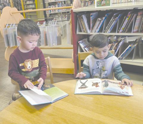 Kids in Perryton gather every week at Perry Memorial Library to enjoy Story Time, which takes place every Wednesday from 10-11 a.m. The program, for kids from 2-4 years old, is free, but library staff request you call ahead and register so they know how many crafts they’ll need to make. Pictured getting a little extra reading done while waiting for the program to start are, from left, Jasiel Ortiz, age 3, and Isael Olmos, 4.