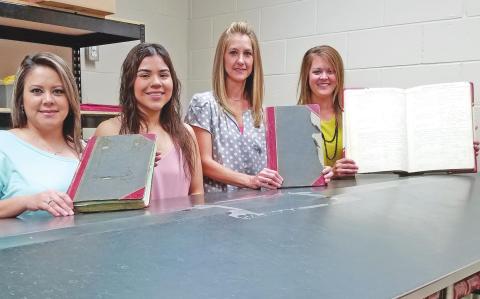 PRESERVING THE COUNTY’S OLDEST RECORDS Three vital record books from the early years of Ochiltree County have been chosen for preservation efforts. Two of the books date from the early decades of the 20th century, while the other stretches all the way back to 1889. Pictured with the three books to be preserved are members of the Ochiltree County Clerk’s office: from left, deputy county clerks Sandra Limas, Dyani Lozano, and Jeri Ann McGarraugh, and county clerk Cassi Laxton.