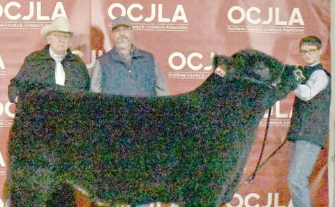 This year’s Grand Champion Steer at the Ochiltree County Junior Livestock Show and Sale on Jan. 17-18 was awarded to Jake Schickedanz. The animal was purchased by Chris Smith Wealth Management, Ag Ingenuity, and Larry Schickedanz (in memory of Charleen and Lecreca). Pictured are, from left, Larry Schickedanz, Jason Duvall, and Jake Schickedanz. ( Photo credit: Morgan Dudley)