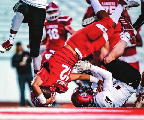 RANGERS ROLL OVER THE COMPETITION Ranger Abraham Hernandez (#12, junior) barrels over a Lobo as the Rangers took an early lead and never looked back on Friday evening versus the Levelland Lobos. The win was their first district game of the season, and they dominated the Lobos 34-7 at Ranger Field. The Rangers’ next game is Thursday, where they travel to Lubbock. (Photo by David Erickson)