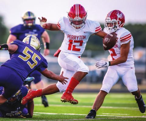 OPENING WITH A WIN Abraham Hernandez (#12, senior) dodged a Dalhart defender as the Perryton Rangers downed the Dalhart Golden Wolves in their season opener Friday in Dalhart. The Rangers notched a win, 27 to 6. They hit the road again next Friday to face the Childress Bobcats. Kickoff is at 7:00 p.m. See story for more information. (Photo by David Erickson)