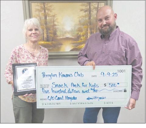 The Perryton Kiwanis Club named Carol Hayden as their Workhorse of the Year on Tuesday evening. She is a retired P.E. teacher at Wright Elementary and a founder of Snack Pak 4 Kids in Perryton. The Kiwanis Club also made a $500 donation to Snack Pak in honor of Hayden. Pictured are, from left, Hayden and Kiwanis president Chase Allison.
