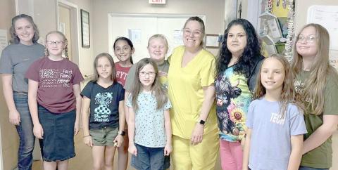 4-H MEMBERS SEW PILLOWCASES FOR CAPSTONE RESIDENTS— Ochiltree County 4-H members in the fashion/beginner sewing class learned basic sewing skills by hand and on the sewing machine. They constructed 19 pillowcases for residents at Capstone Healthcare of Perryton as a final project. Pictured are, from left, senior leader Rylan Oquin, Hannah Young, Izzy Heck, Madison Knox, Isabella Gonzalez, Madison Knox, Rebekah Young, Capstone LVN Melissa Windham, CNA Gloria Gonzales, Gabby Heck and Kylee Knox.