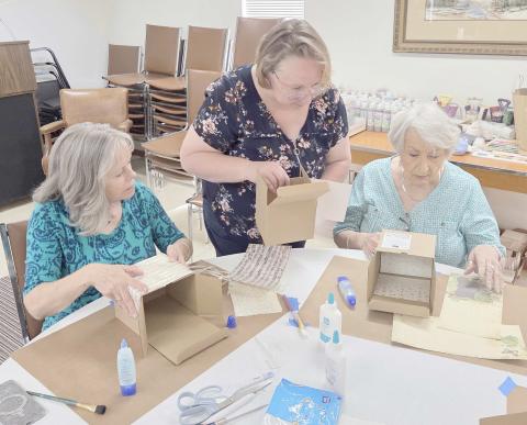 The Ochiltree County Senior Citizens Association hosted a crafting project for members at Senior Center on Monday afternoon, as staff at Paper and Cloth Memories demonstrated how to make memory boxes. Pictured are, from left, Becky Childers, Brenda Austin, and Berwyn Flowers.