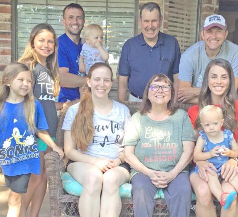 Cindy Shackelford and family: at left, son Scott, his wife Kami and daughters Emma, Zoey and Saylor; and at right, son Ben and his wife Annie with son Caleb; and behind her, husband Danny