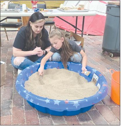 Family Archaeology Day, held last Saturday at the Museum of the Plains, gave kids and adults lots of ways to learn about the science of archaeology, including carefully sifting through an artificial archaeology dig to find artifacts, fossils, unusual stones, and more. Attendees at the event also got to enjoy art, crafts, games, and much more. Pictured looking for artifacts in the artificial archaeology dig are Lauren Goza and Juliza Thomas, age 7.