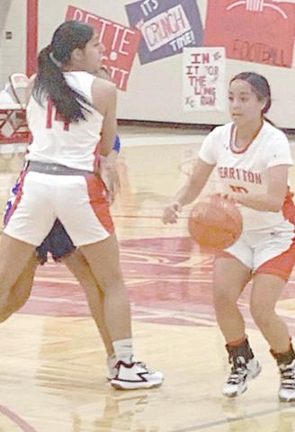 RETTE BASKETBALL—The Rangerettes hosted the Canyon Lady Eagles Tuesday in their second district game. The Lady Eagles dominated the contest, winning 73-33. Above, point guard Tonya Navarrete (10) dribbles by a pick set by Analia Loera (14) on her way to the bucket.