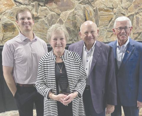 Cynthia Symons received congratulations from many well-wishers after she was named the Citizen of the Year on Feb. 19 during the Perryton-Ochiltree Chamber of Commerce’s annual banquet. Pictured are, from left, banquet emcee Dr. Jay Blasingame, Cynthia Symons, Kerry Symons, and presenter Randy Brillhart.