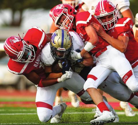 SEASON OPENER CUT SHORT The 2020 season opener at Ranger Field was cut short due to a power outage just minutes before the opening of the second half. A rabble of Rangers including senior Jacob Schollenbarger, #11; junior Cuyler Feger #5, and senior Pablo Perez #13 bring down the Dalhart running back late in the first quarter. (Photo by David Erickson)