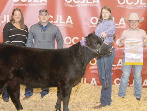 RESERVE GRAND CHAMPION HEIFER— At the Ochiltree County Junior Livestock Show and Sale, the prize for Reserve Grand Champion Heifer went to Tana Williams. Her animal was bought by Hansford County Vet, Hansford County Vet Supply, and TK Cattle. Pictured are, from left, Kris and Tod Keeth, Tana Williams, and Hadlee Cowan. (Photo credit: Tessa Powell)