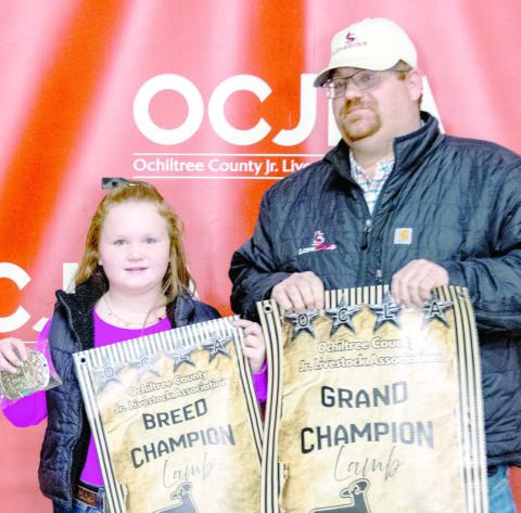At the Ochiltree County Junior Livestock Show and Sale on Jan. 16-17, the prize for Grand Champion Sheep went to Bryar Herod. His animal was bought by Bank of Western Oklahoma-Woodward . Pictured are, from left, Bryar Herod and Matthew Gillispie. ( Photo credit: Hailey Clark of Hailey Renee Photography)