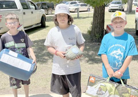 Enthusiastic young fishing fans came out for the Children’s Fishing Tournament at Lake Fryer and Wolf Creek Park at the beginning of June. Pictured are, from left, the top winners in the category for kids ages 7-10, Carson Barkley (third place), Christian Shipley (second place), and Slade Savard (first place).