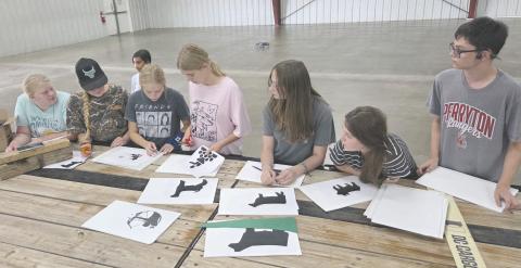 Many organizations and businesses are hard at work preparing their floats for Saturday’s Wheatheart of the Nation Celebration parade, which will march down Main Street starting at 10 a.m. Pictured making plans for decorations for the Ochiltree County 4-H float are, from left, Rebekah Young, Hannah Young, Eden Salazar (in the background), Emmalee Lopez, Darlee George, Kylee Knox, Kaylynn Tarango, and Lou Tarango.