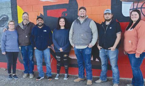 MURAL ARTST— THE new mural on the back of Perryton Glass and Overhead Doors includes several images of Perryton. Artist Mario Enriquez spent about five weeks painting the mural. Pictured are, from left, Perryton Glass owners,Lea Thomas and Brian Thomas, Enriquez, his daughter Mariah Hollibaugh who assisted on the project, Brayton Thomas, Keaton Burt, and Morgan Thomas.