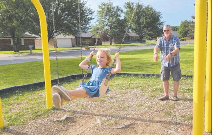 After several days of brutally hot weather, Ochiltree County finally got a small cooldown on Wednesday morning. Still, summer’s heat meant that many resident preferred to get their outdoor work and play done in the morning, when it was coolest. Pictured enjoying the swings at Whippo Park are Kinley Stevenson, age 6, and Matt Sheppard.