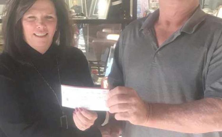 Perryton Elks Lodge 2368 donated $4,000 to the VA Hospital in Amarillo to help with supplies for residents of the facility. The donation was made possible through one of the grant programs available to Elks Lodges across the country. Pictured are VA representative Trisha Reid, left, and Elks Exalted Ruler Dewayne Holdeman.