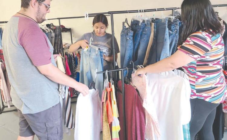 The Panhandle Crisis Center’s Resale Store opened at a new temporary location at 21 SE 12th Street on August 1. The old store sustained heavy damage in the tornado on June 15. The store will be open Monday through Friday from 10 a.m. to 5:30 p.m. No donations are being accepted at this time. Pictured getting the store restocked prior to its opening are, from left, Rhett Schaef, Jade Gonzales, and Marisol Hernandez.