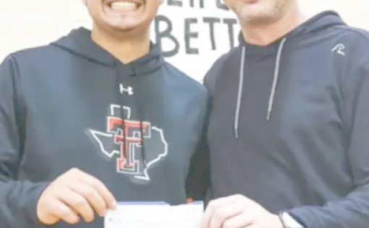 BIG WINNER—Zach Valdez, left, was the big winner in a half-court shot contest sponsored by Perryton Realty during the Ranger and Rangerette basketball games.. He pocketed $500 for making the impressive shot on Feb. 6. To encourage students’ attendance at games, raffle tickets were given to all students attending. If their ticket was drawn, they had a shot at the big prize. Pictured with him is Perryton Realty owner Bryce Hale.