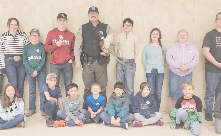 ALAMO CLUB GUEST SPEAKER—Game Warden Jeremy Schwalk was the guest speaker for the Alamo 4-H Club. Pictured are first row, from left, Madison Knox, Matt Oquin, Kyren Rodriguez, Dawson Young, Xander Gonzalez, Gracie Love, Jayden George and Clay Oquin; and in back, Kylee Knox, Rylan Oquin, Brady Oquin, Kyle Oquin, Schwalk, Louie Tarango, Kaylynn Tarango, Rebekah Young and Nathan Knox.