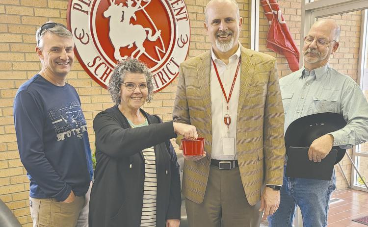 The candidates for the Perryton Independent School District board election met on Monday afternoon at the PISD Administration Building to draw for ballot position for the election. Jeff Schollenbarger will be in first position on the ballot, followed by Bryce Hale, Wes Beal, Nuno Rodriguez, Chris Lingo, and Kevin Pshigoda. Pictured are, from left, Schollenbarger, payroll clerk Lesa Kemp, who drew the names for the ballot, PISD Superintendent Greg Brown, and Beal.