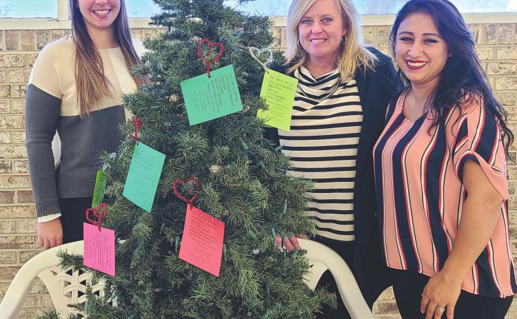 BE A CHRISTMAS ANGEL The Panhandle Crisis Center is offering the opportunity to help children in need this Christmas with the Angel Tree Project, with Angel Trees set up in local businesses to let benefactors purchase gifts for kids. Pictured with the Angel Tree in Walls Discount Center are, from left, crisis center staff members Jessica Klopper, Brada Hargues, and Carmen Mercado.