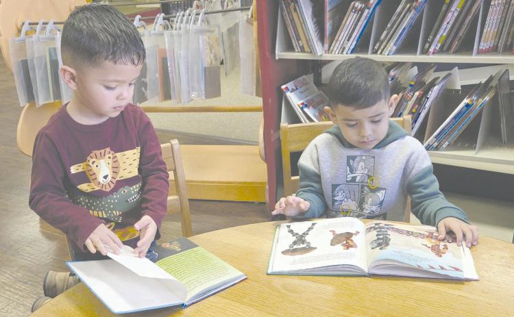 Kids in Perryton gather every week at Perry Memorial Library to enjoy Story Time, which takes place every Wednesday from 10-11 a.m. The program, for kids from 2-4 years old, is free, but library staff request you call ahead and register so they know how many crafts they’ll need to make. Pictured getting a little extra reading done while waiting for the program to start are, from left, Jasiel Ortiz, age 3, and Isael Olmos, 4.
