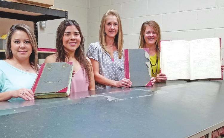 PRESERVING THE COUNTY’S OLDEST RECORDS Three vital record books from the early years of Ochiltree County have been chosen for preservation efforts. Two of the books date from the early decades of the 20th century, while the other stretches all the way back to 1889. Pictured with the three books to be preserved are members of the Ochiltree County Clerk’s office: from left, deputy county clerks Sandra Limas, Dyani Lozano, and Jeri Ann McGarraugh, and county clerk Cassi Laxton.