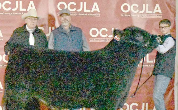 This year’s Grand Champion Steer at the Ochiltree County Junior Livestock Show and Sale on Jan. 17-18 was awarded to Jake Schickedanz. The animal was purchased by Chris Smith Wealth Management, Ag Ingenuity, and Larry Schickedanz (in memory of Charleen and Lecreca). Pictured are, from left, Larry Schickedanz, Jason Duvall, and Jake Schickedanz. ( Photo credit: Morgan Dudley)