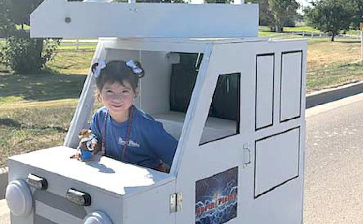 PARADE CHAMP NON-PROFIT FLOAT– Perryton’s Wheatheart of the Nation Celebration parade brought thousands of viewers out to enjoy the show on Saturday, Aug. 24. The winner of the Non-Profit division of parade entries was the float for North Plains Electric Coop, featuring the mini bucket truck driven by Evie Peregrino, age 3.