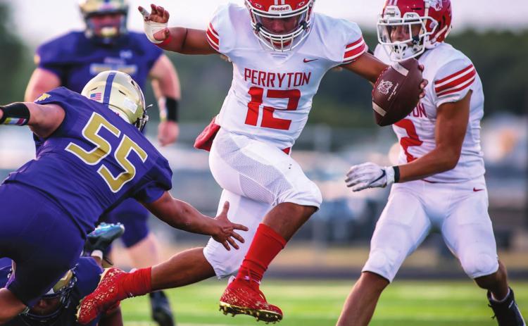 OPENING WITH A WIN Abraham Hernandez (#12, senior) dodged a Dalhart defender as the Perryton Rangers downed the Dalhart Golden Wolves in their season opener Friday in Dalhart. The Rangers notched a win, 27 to 6. They hit the road again next Friday to face the Childress Bobcats. Kickoff is at 7:00 p.m. See story for more information. (Photo by David Erickson)