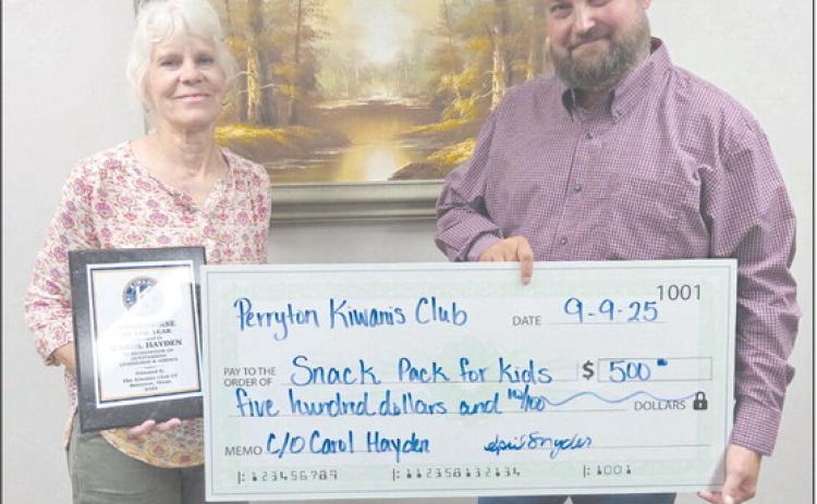 The Perryton Kiwanis Club named Carol Hayden as their Workhorse of the Year on Tuesday evening. She is a retired P.E. teacher at Wright Elementary and a founder of Snack Pak 4 Kids in Perryton. The Kiwanis Club also made a $500 donation to Snack Pak in honor of Hayden. Pictured are, from left, Hayden and Kiwanis president Chase Allison.
